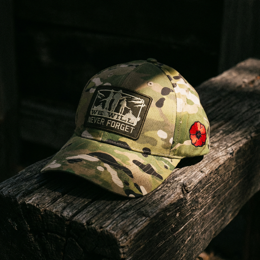 Camouflage baseball cap with a patch on a wooden surface